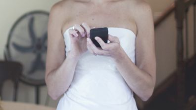 Bride texting on phone