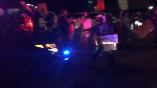 A protester demonstrating against the police shooting of Stephon Clark was hit by a police car last night, sparking violence after weeks of tension. Picture: Supplied.