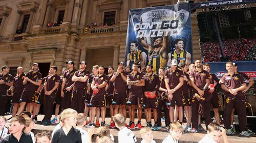 The Hawks gather on stage in front of an enormous crowd of fans. (Getty Images)