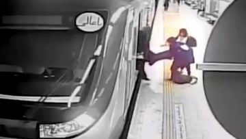 Women pull Armita Geravand from a train car on the Tehran Metro in Tehran