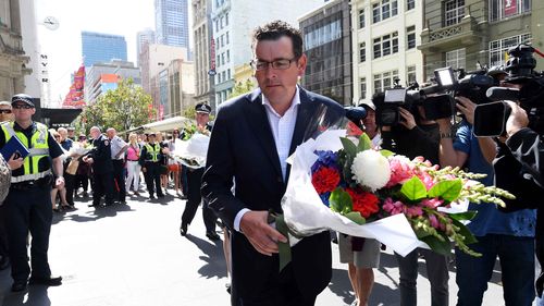 Victorian Premier Daniel Andrews lays flowers on the corner of Bourke and Elizabeth Street after a man went on a rampage in a car through busy Bourke St mall 