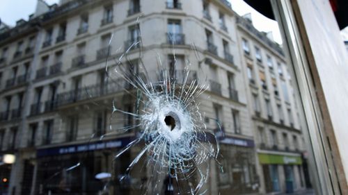 A bullet hole seen on the window of a cafe located near the area where the assailant of a knife attack was shot dead by police officers. (AP).