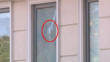 Bullets hit the windows of the property. None of the five residents inside were injured.
