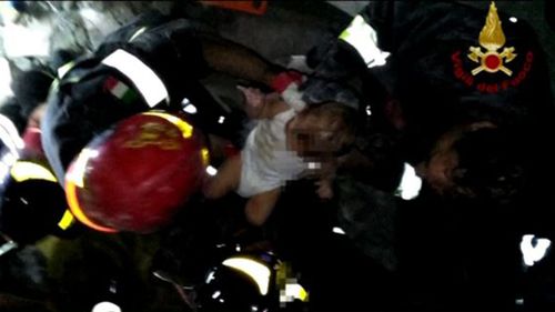 Fire crews worked quickly to rescue the baby from the rubble. (Reuters)