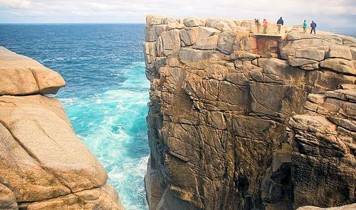 The man, believed to be aged in his 20s, hit the rocks below, before being dragged out to sea. (File)