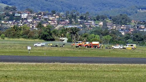 Emergency services work at the crash site at Shellharbour Airport.