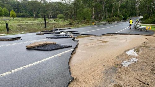 Floodwaters caused a portion of the road in north-west Sydney to wash away. 