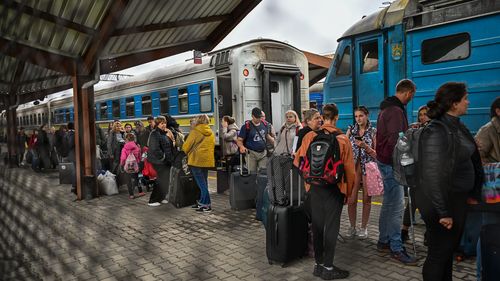 Ukrainians carry their bags as they get off a train from Zaporizhzhia at Przemysl train station on September 30, 2022 in Przemysl, Poland. Russia declared the annexation of 15 percent of Ukrainian territory, sending more Ukrainians to flee across the border into Poland whilst other Ukrainian refugees who struggled to settle in Europe since the Russian invasion in February are crossing back into Ukraine. (Photo by Omar Marques/Getty Images)