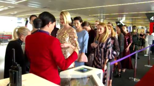 The models wait to "check in" to their flight from Sydney to Melbourne. (9NEWS)