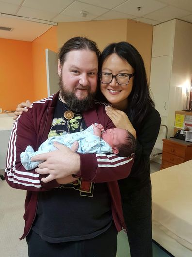 Kris and Sarah Yip cuddle up to their newborn son.