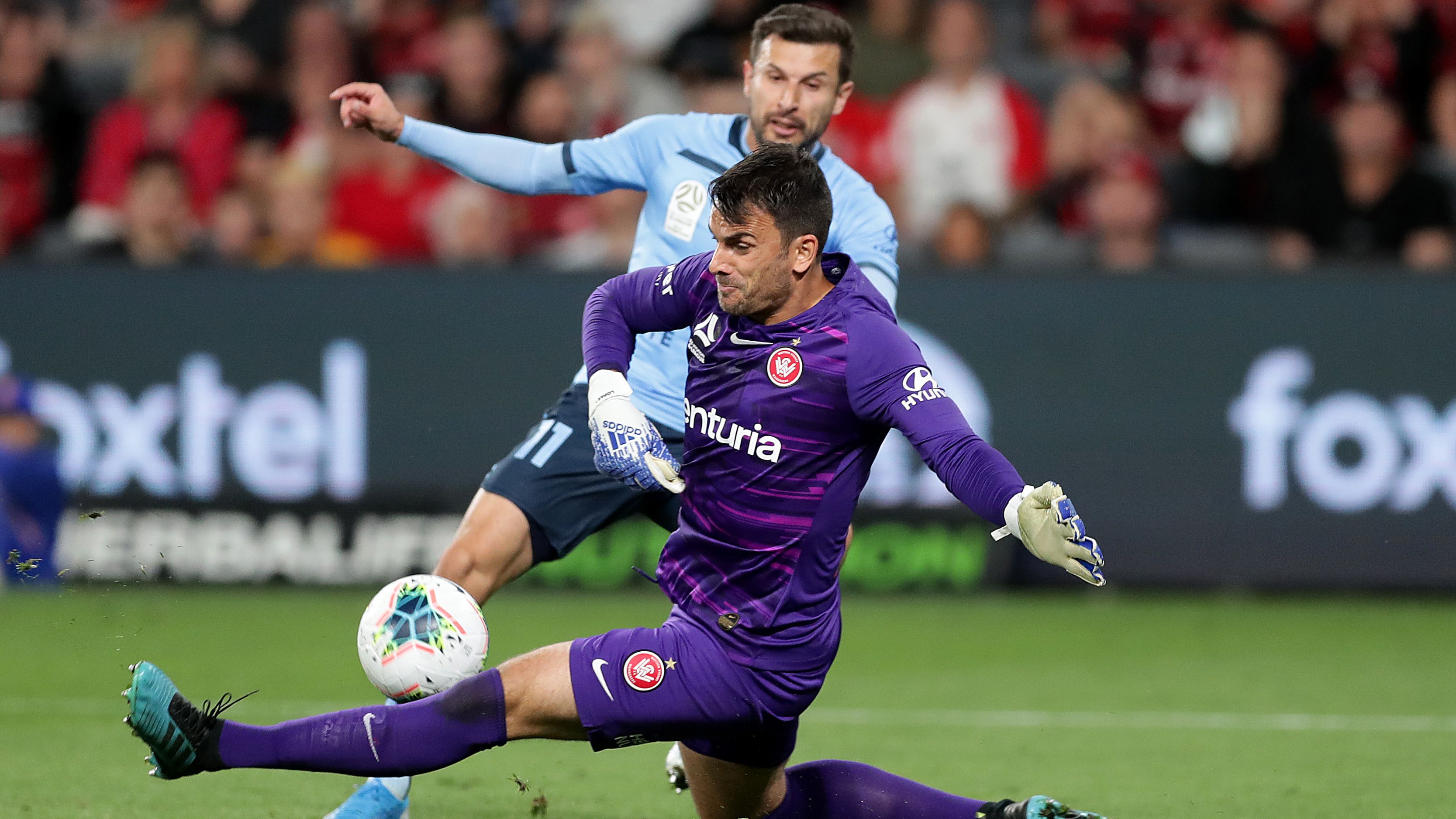 Daniel Lopar of the Wanderers saves from Kosta Barbarouses of Sydney FC at Bankwest Stadium.