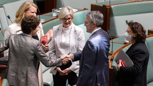 Attorney-General Mark Dreyfus (second from right) with crossbenchers after the National Anti-Corruption Commission Bill passed parliament.