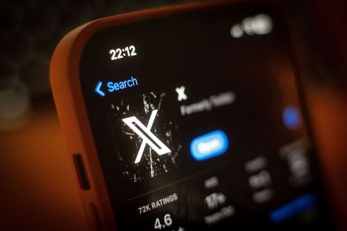 The X app, formerly Twitter is seen on the Apple App Store is seen in this photo illustration on 13 March, 2023 in Warsaw, Poland. Elon Musk's X has been hit by three waves of outages since this morning, which the billionaire claims was due to a cyberattack.