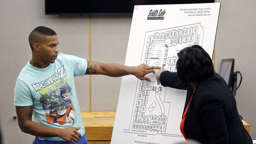 Botham Jean's neighbor Joshua Brown, left, answers questions from Assistant District Attorney LaQuita Long, right while testifying during the murder trial of former Dallas Police Officer Amber Guyger, in Dallas. 