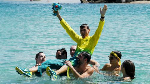 Bird-Smith is held up by his friends after winning gold. (AAP)