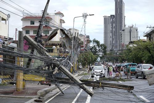 Toppled electrical posts lie along a street in Cebu city in central Philippines. 