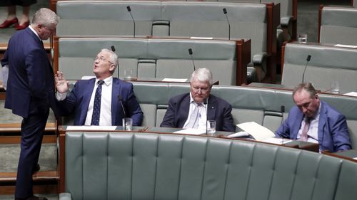 Deputy Prime Minister Michael McCormack speaks with Nationals MP Damian Drum during Question Time at Parliament House.