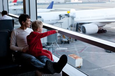 family of two at the airport enjoying time together before airplane departure