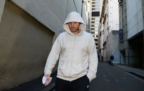 Mr Hampton leaves Central Local Court in 2014 after he was charged with 12 corruption and bribery offences. (AAP)