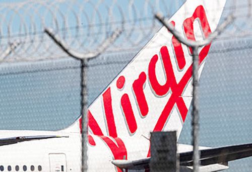 Virgin Australia jet behind razor wire (Getty)