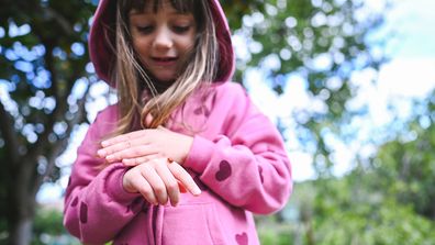Young girl with a ladybug on her hand