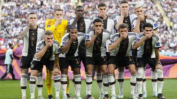 Players from Germany pose for the team photo as they cover their mouth during the World Cup group E soccer match between Germany and Japan, at the Khalifa International Stadium in Doha, Qatar, Wednesday, Nov. 23, 2022.