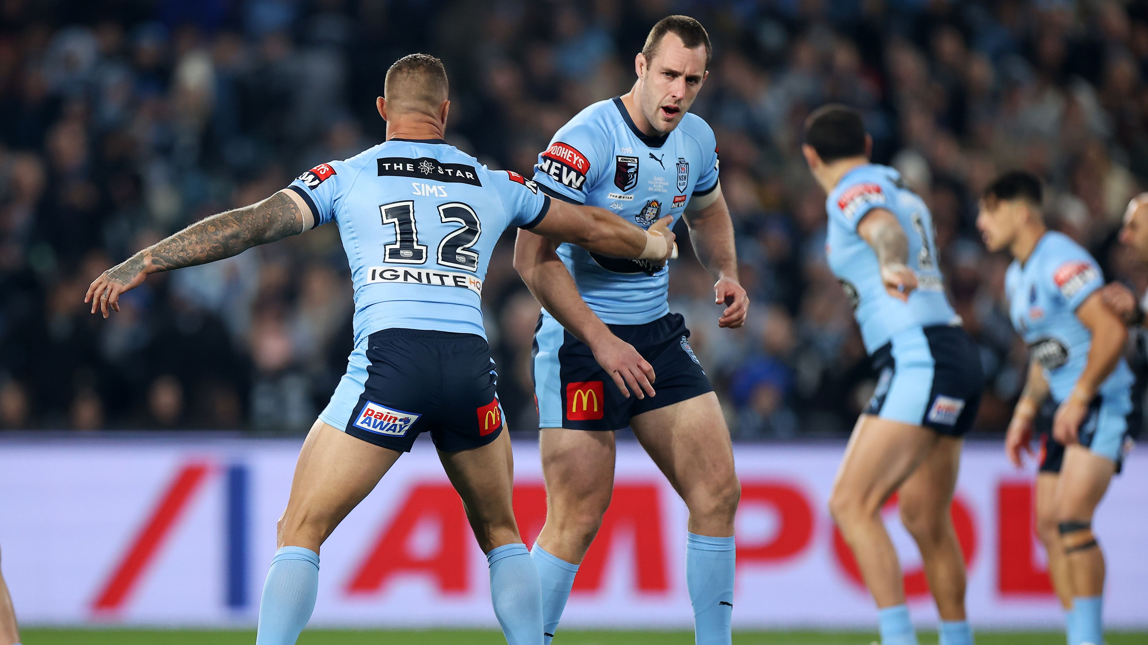 Isaah Yeo was supported by teammate Tariq Sims after stumbling out of the first tackle of Origin game one on Wednesday night. Image: Getty