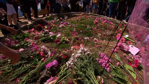 Friends and family laid flowers and wore pink  - Lyn's favourite colour.