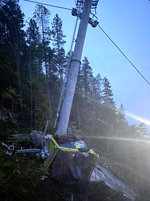 A car from the Sea-to-Sky Gondola lies crumpled on the ground after the cable was cut on Monday (local time).