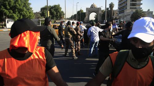 Security forces prevent protesters denouncing election results from storming the heavily fortified Green Zone during a protest in Baghdad, Iraq.