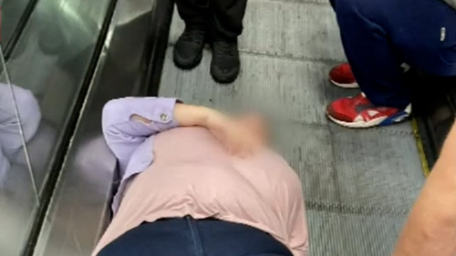 Woman trapped in escalator robbed while she waited to be freed