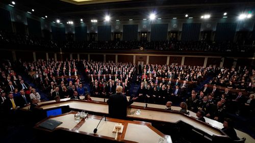 Republicans were boisterous during Mr Trump's address, often rising to cheer, while Democrats were subdued. (AAP)