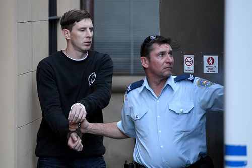 Ryan Evans is escorted to a prison van by Corrective Service officers at the NSW Supreme Court in June. (AAP)