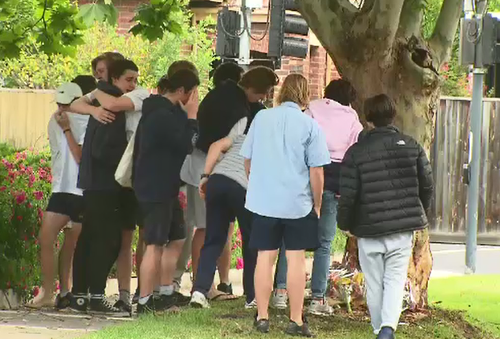 Distraught friends lay flowers for Hector Ryan. (9NEWS)