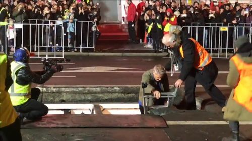 Hundreds anxiously watched on a drizzly Sunday night as the 73-year-old was dug up from Macquarie Street in the heart of the city. Picture: 9NEWS