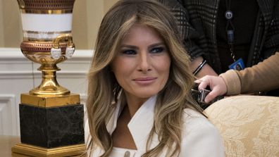 Melania Trump sitting on a lounge chair