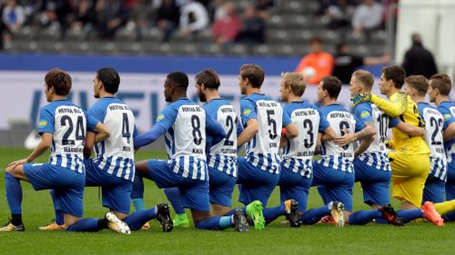 Hertha Berlin players took a knee to show solidarity with US NFL players. (AP)