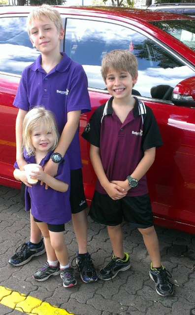 Leah children standing in front of car