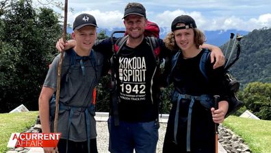 Former footy player Mark Hughes (middle) with his family taking on the Kokoda trail. 