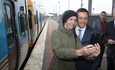 Mr Guy seizes the opportunity to take a selfie with a supporter at Cranbourne railway station, where the Coalition has pledged nearly $500 million to extend the Cranbourne to Clyde train line.