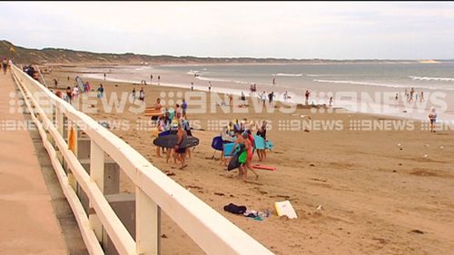 Beach-goers packed up after being warned of the large shark. (9NEWS)