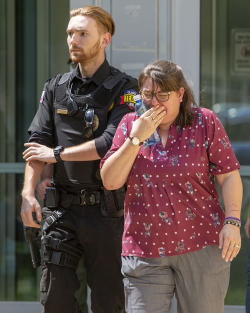 A woman cries Tuesday May 24, 2022 as she leaves the Uvalde Civic Center. 