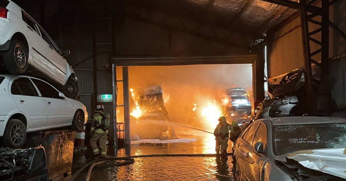 Fire at car wrecking yard to burn overnight in Sydney’s south-west
