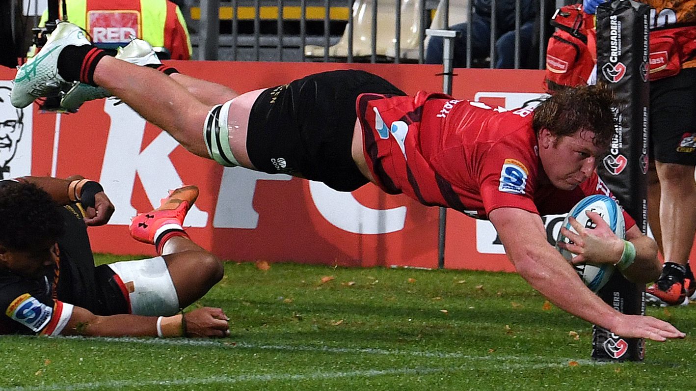 Cullen Grace of the Crusaders dives over to score a try during the round six Super Rugby Pacific match against the Chiefs.