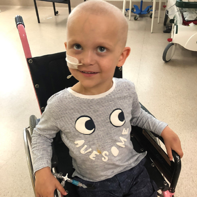 Ollie leukaemia sitting in a wheelchair