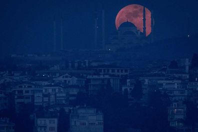 A Super Blue Blood Moon rises behind the Camlica Mosque on January 31, 2018 in Istanbul, Turkey.