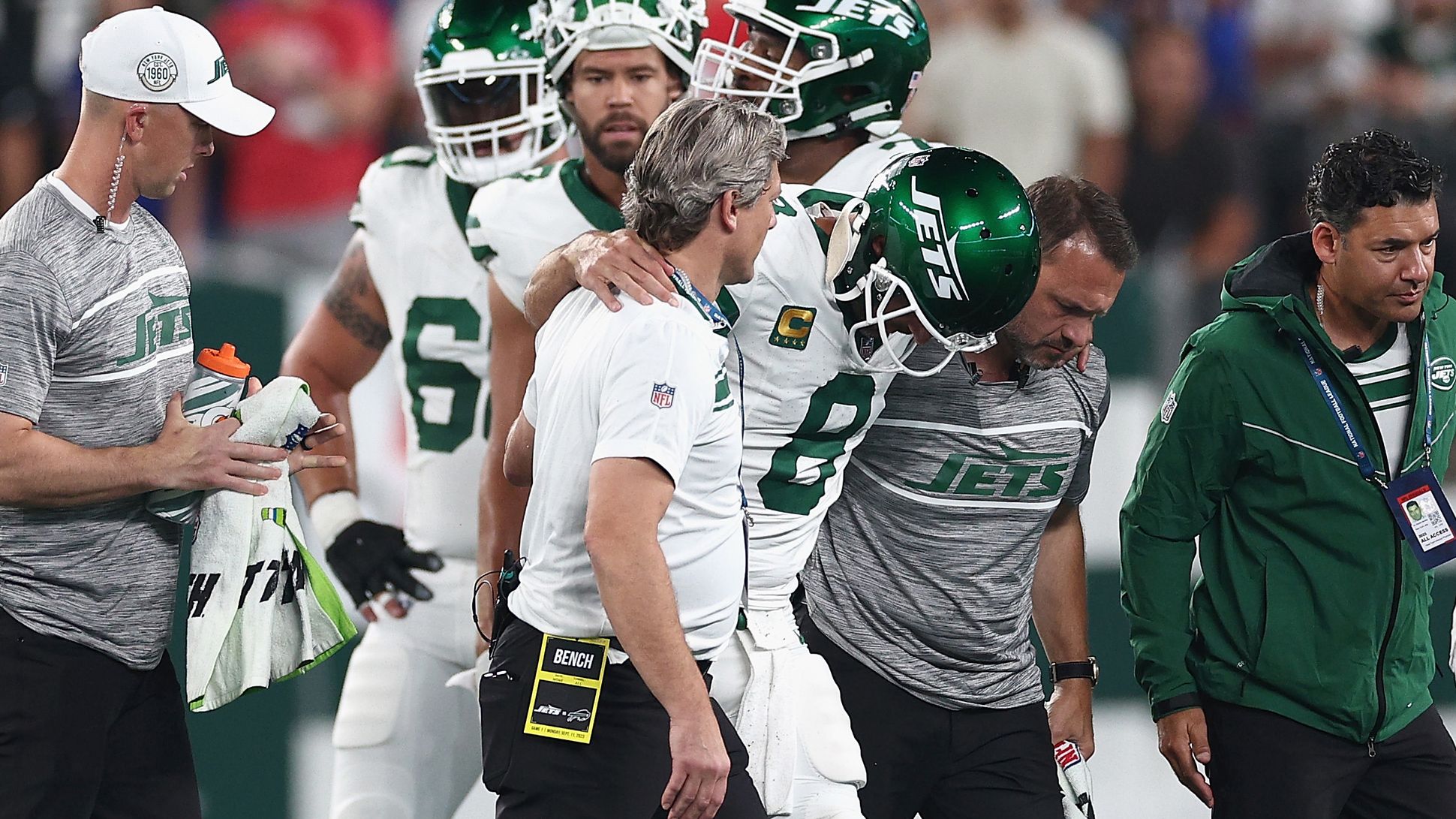 Quarterback Aaron Rodgers of the New York Jets is helped off the field.
