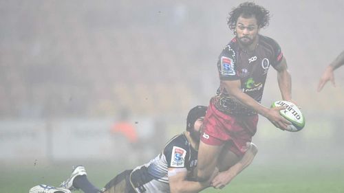 Reds fullback Karmichael Hunt is tackled by Brumbies flanker Scott Fardy in the heavy fog at Suncorp Stadium. (AAP)