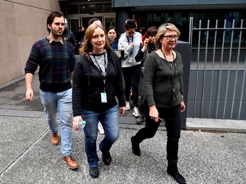 Staff at the ABC in Ultimo, Sydney, leave their offices ahead of this afternoon's meeting to discuss political interference.