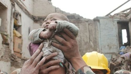 This four-month-old baby was rescued 22 hours after the quake first struck. (9NEWS)